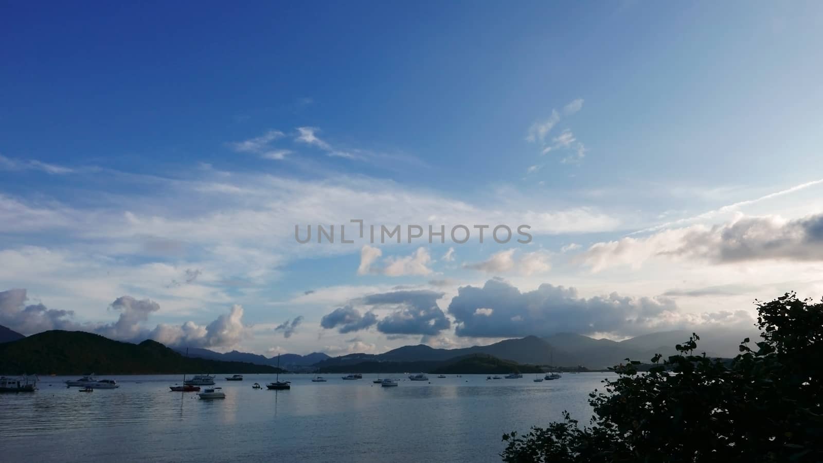 Boat, lake, mountain, blue sky and the clouds