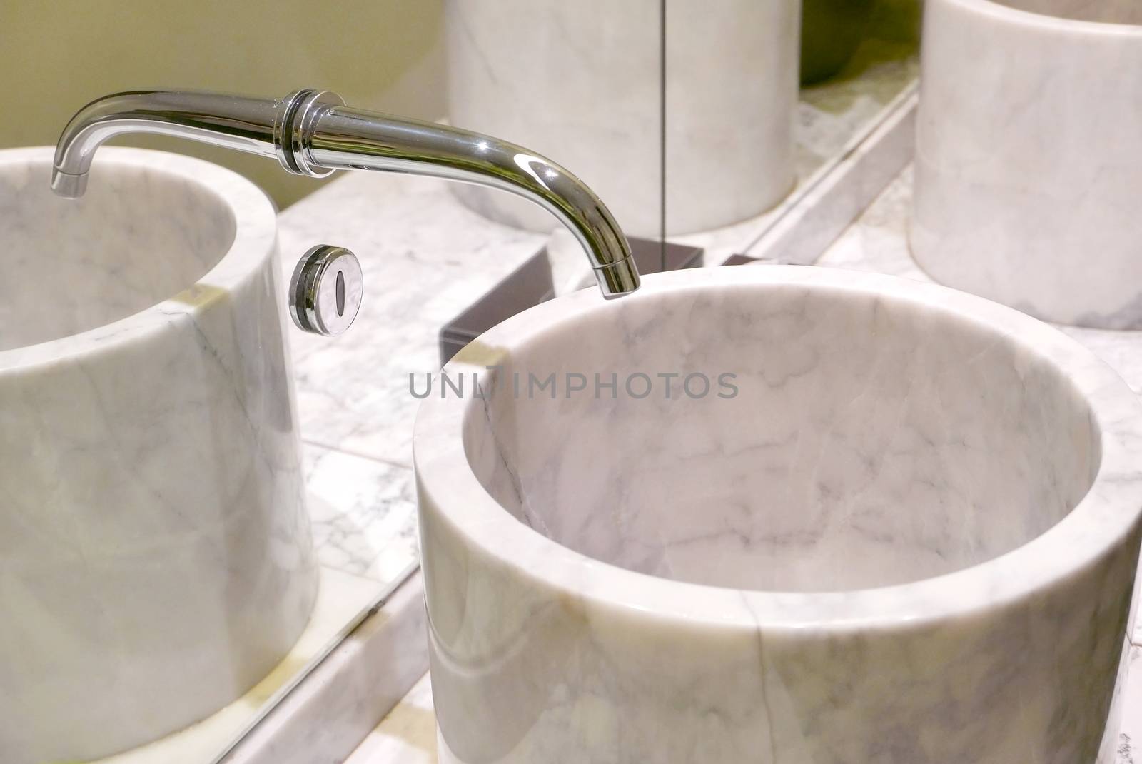 Indoor modern water sink with mirror reflection in restroom by cougarsan