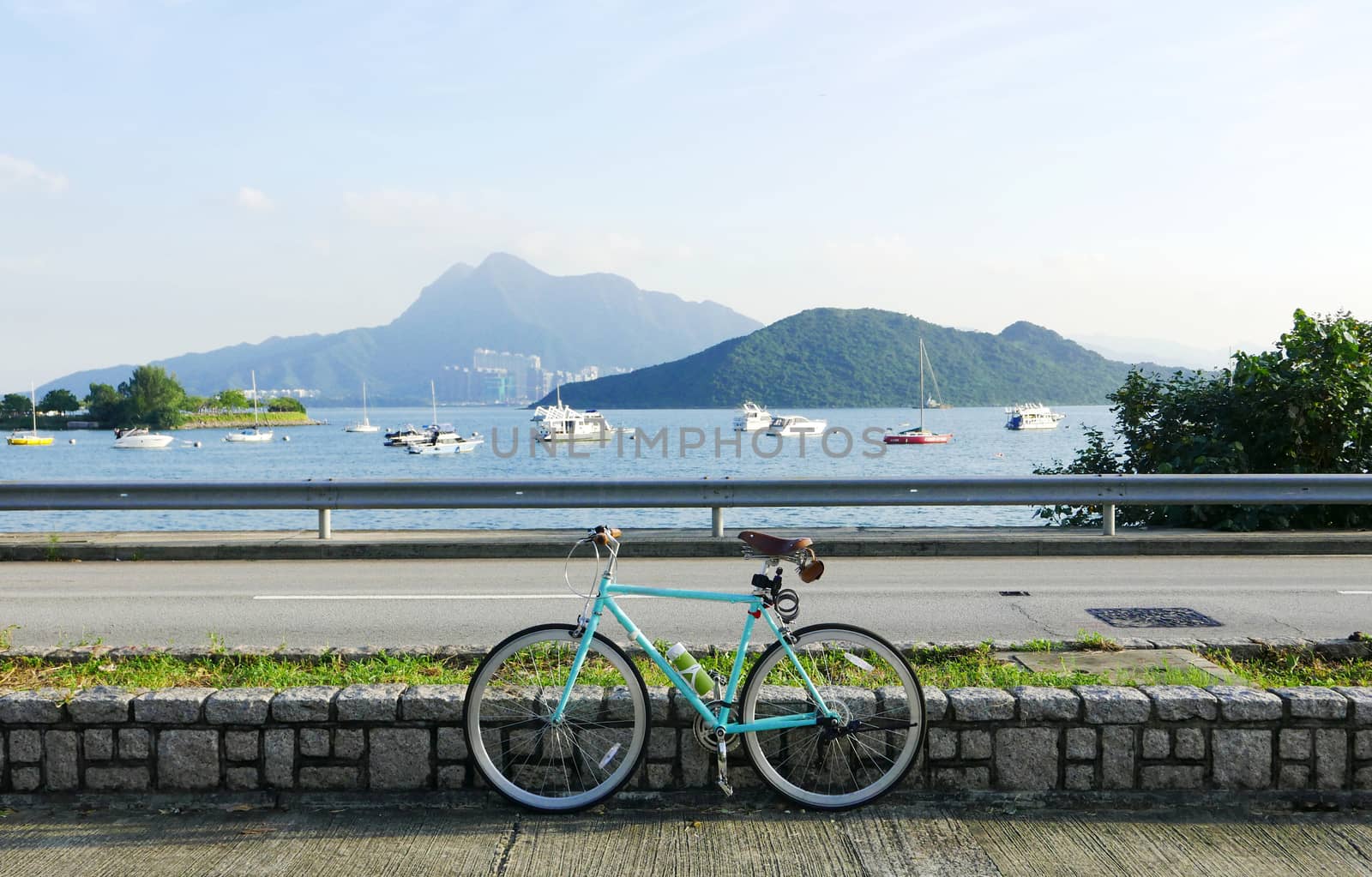 Mint green retro parked bicycle near lake and road by cougarsan