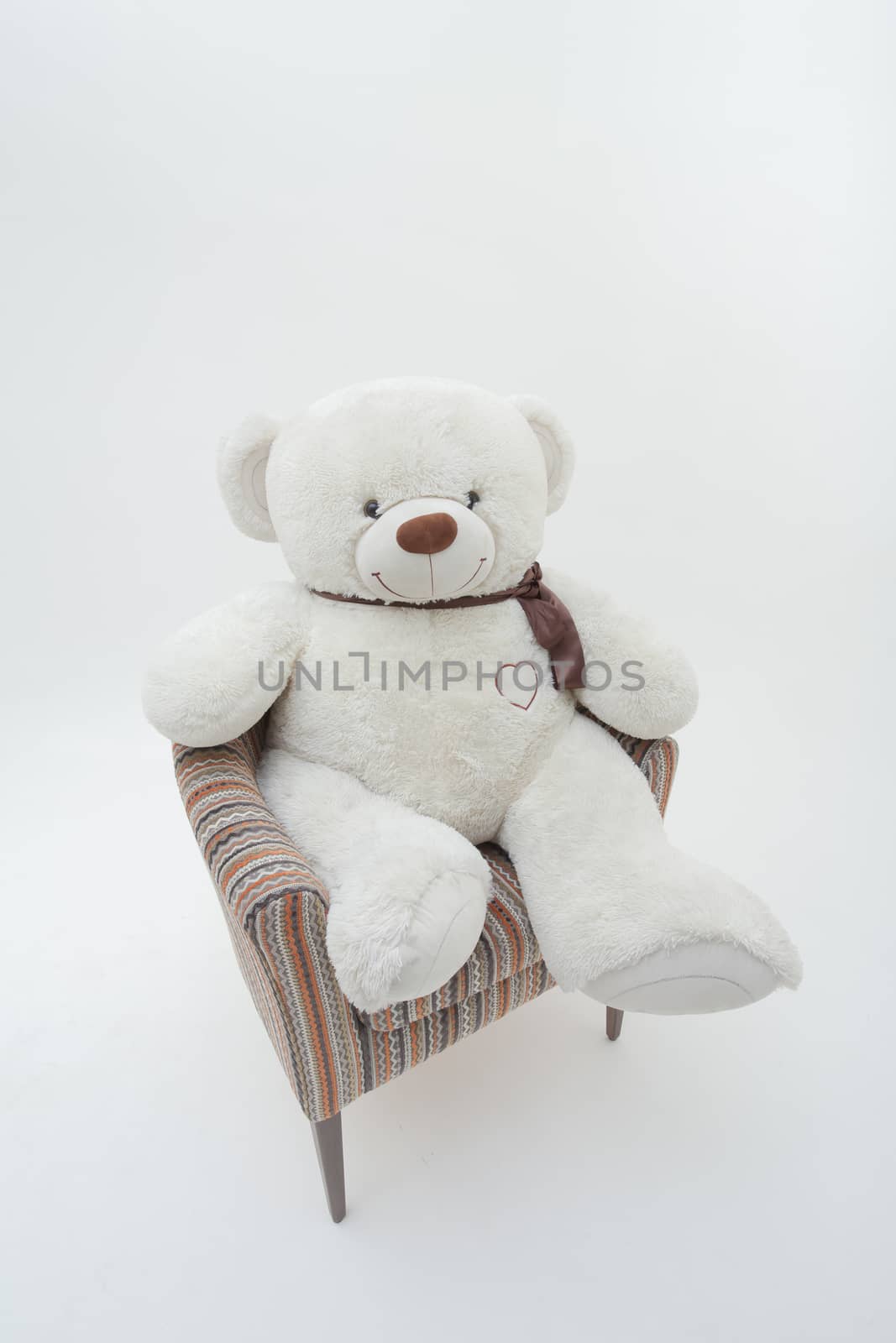 Teddy bear and classic soft chair on white blackground