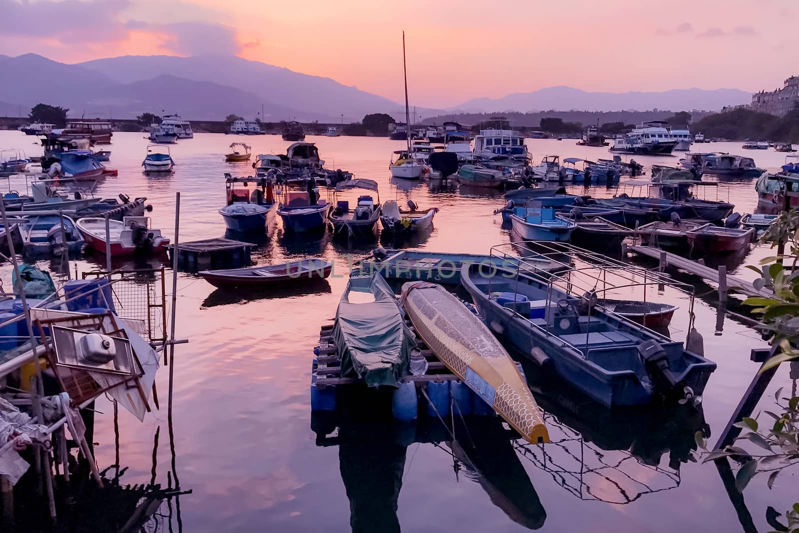 Fishing boats with water reflection in wharf by cougarsan