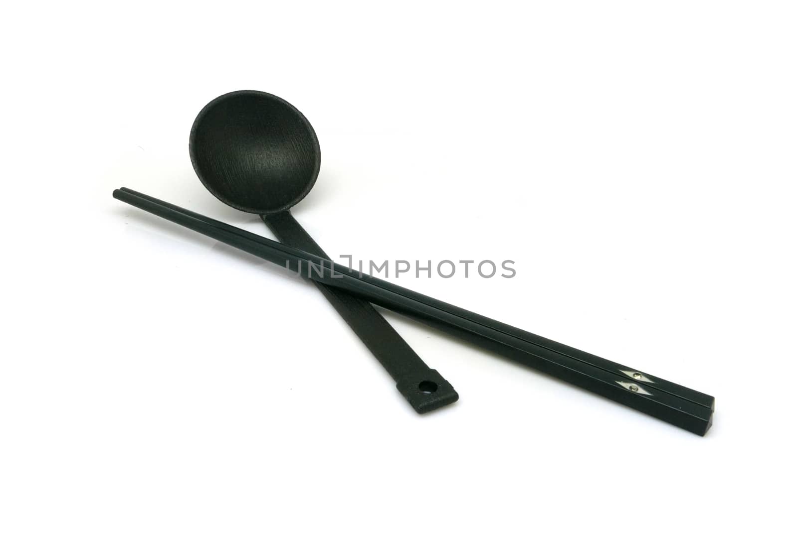 Black spoon and chopsticks isolated on white background by cougarsan