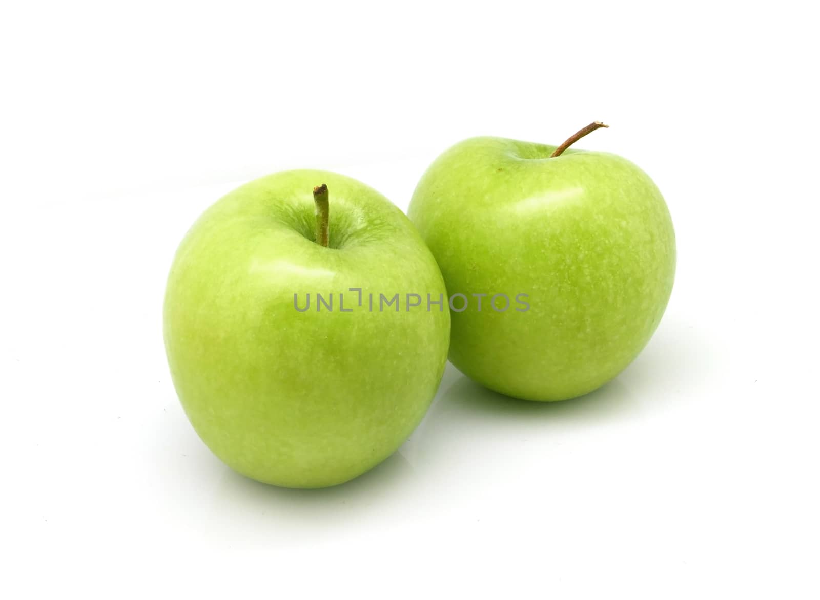 Two green apples on white background by cougarsan