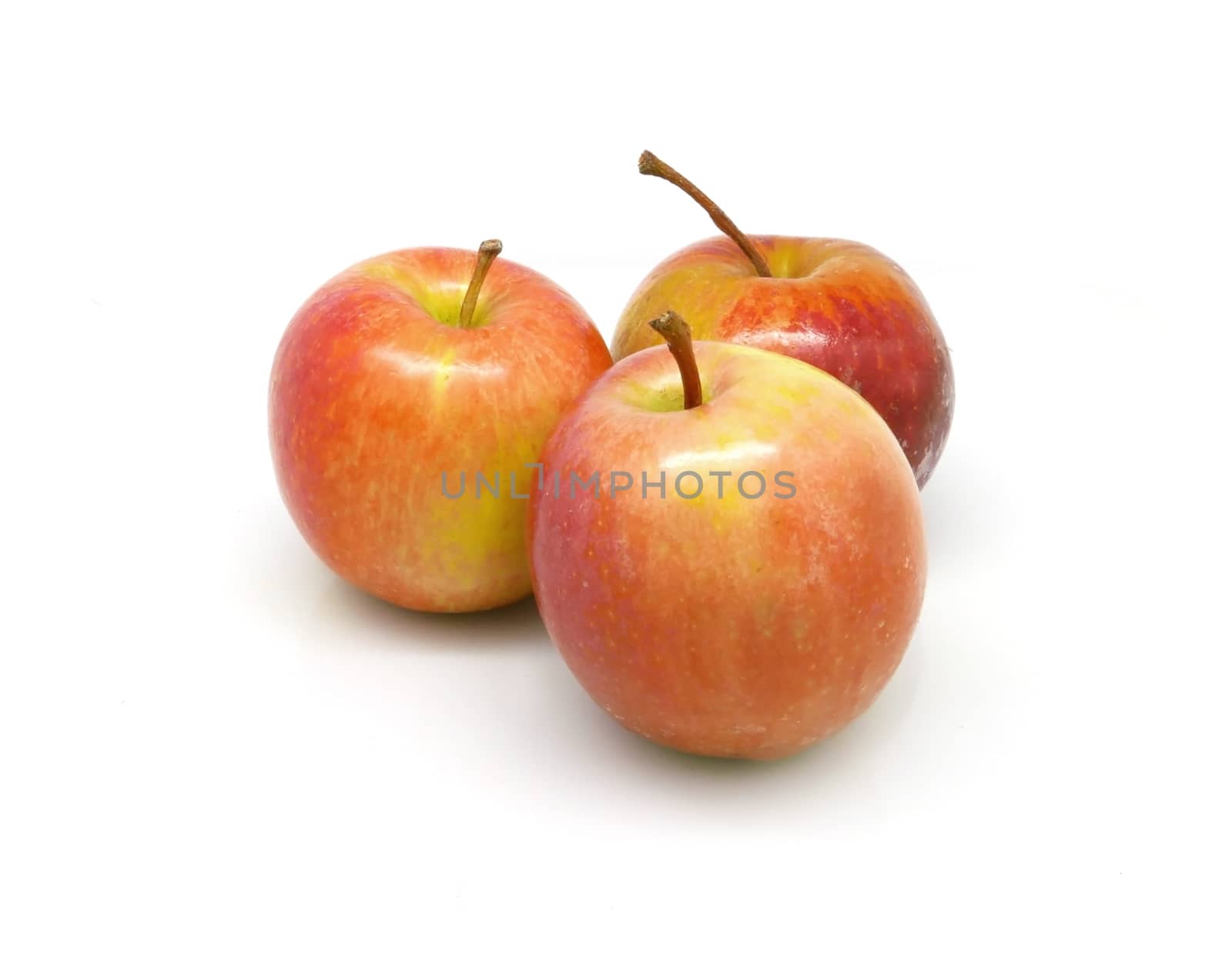 three red apples on white background