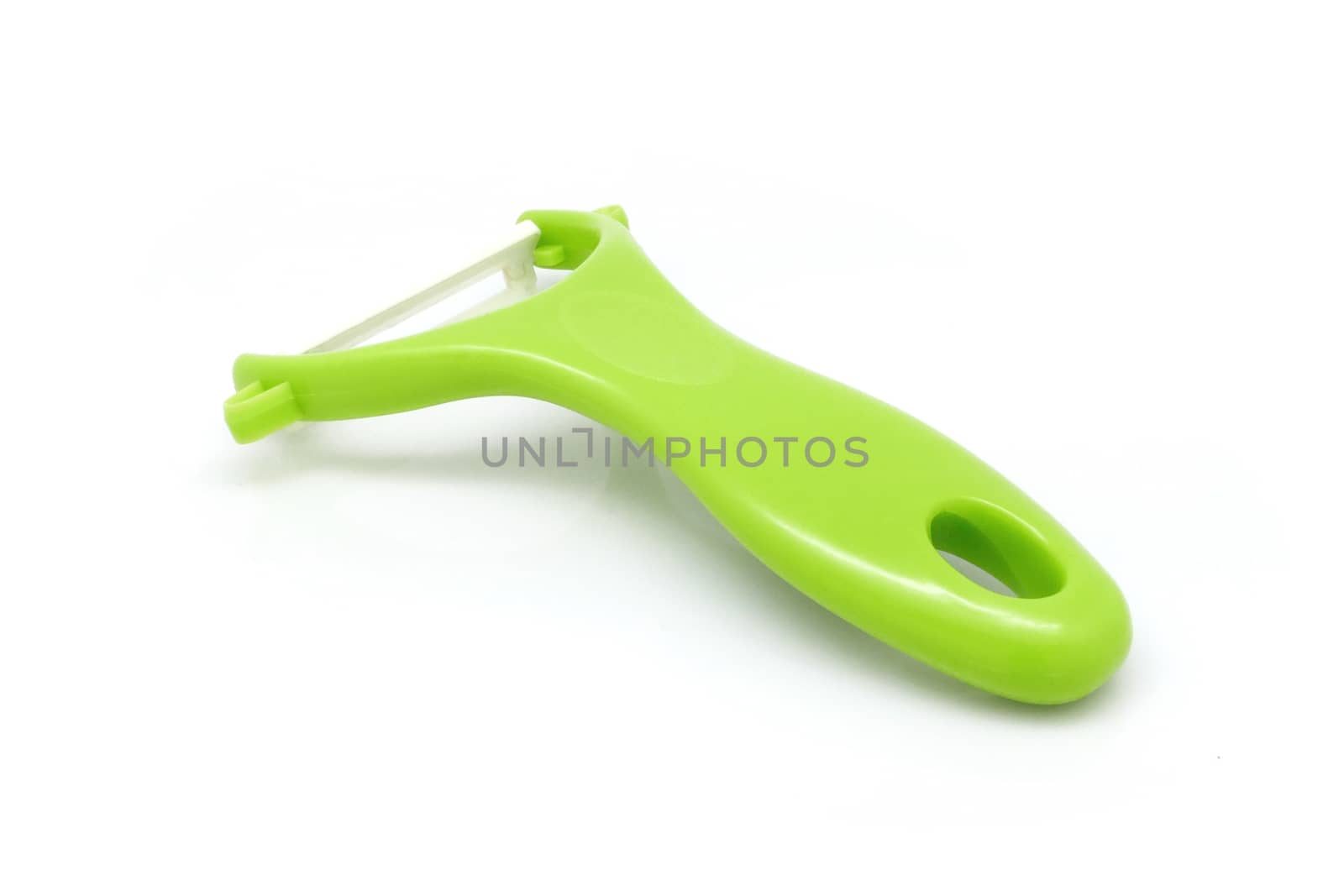 Green fruit skin peeler isolated on white background