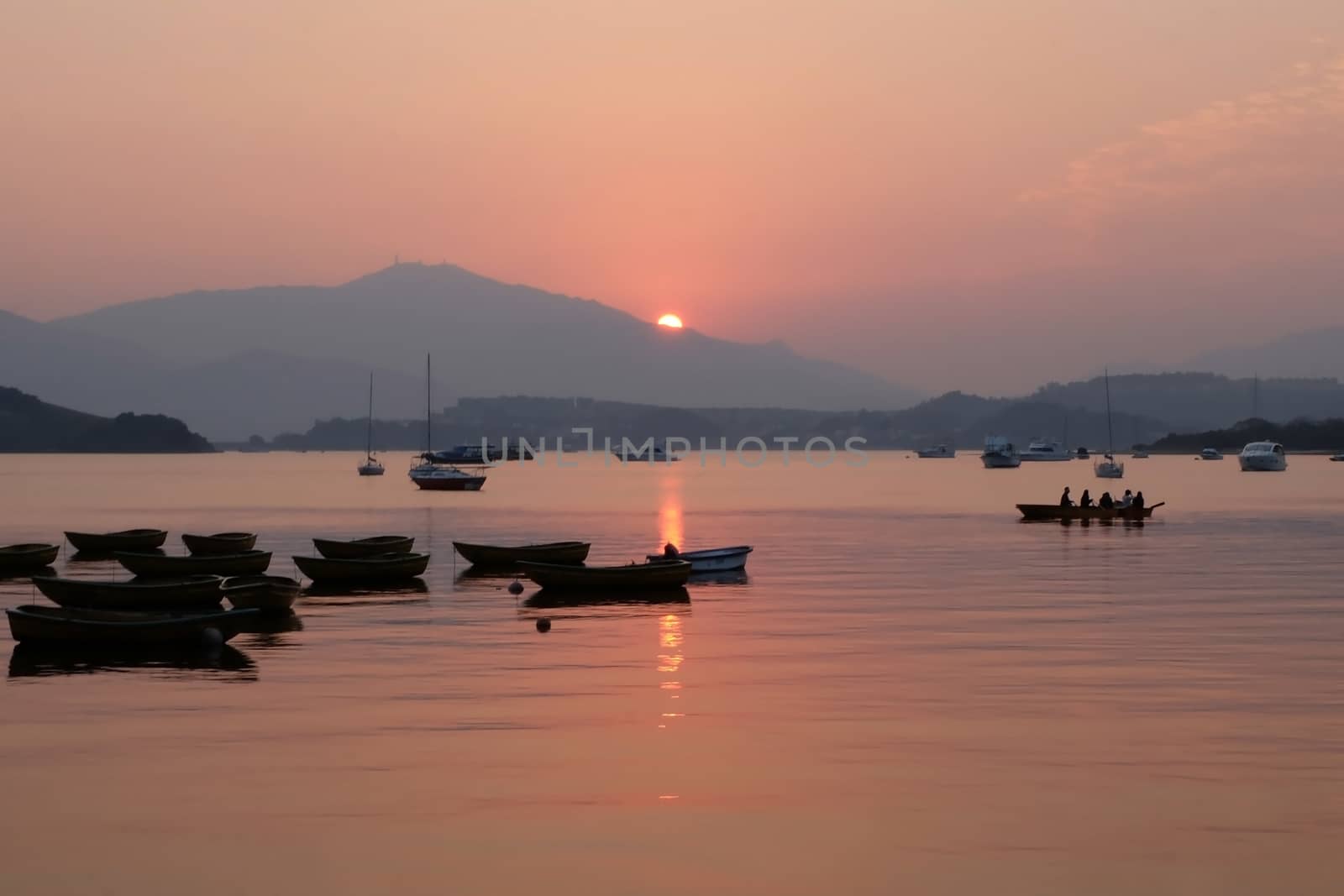 recreational boats on the lake at sunset