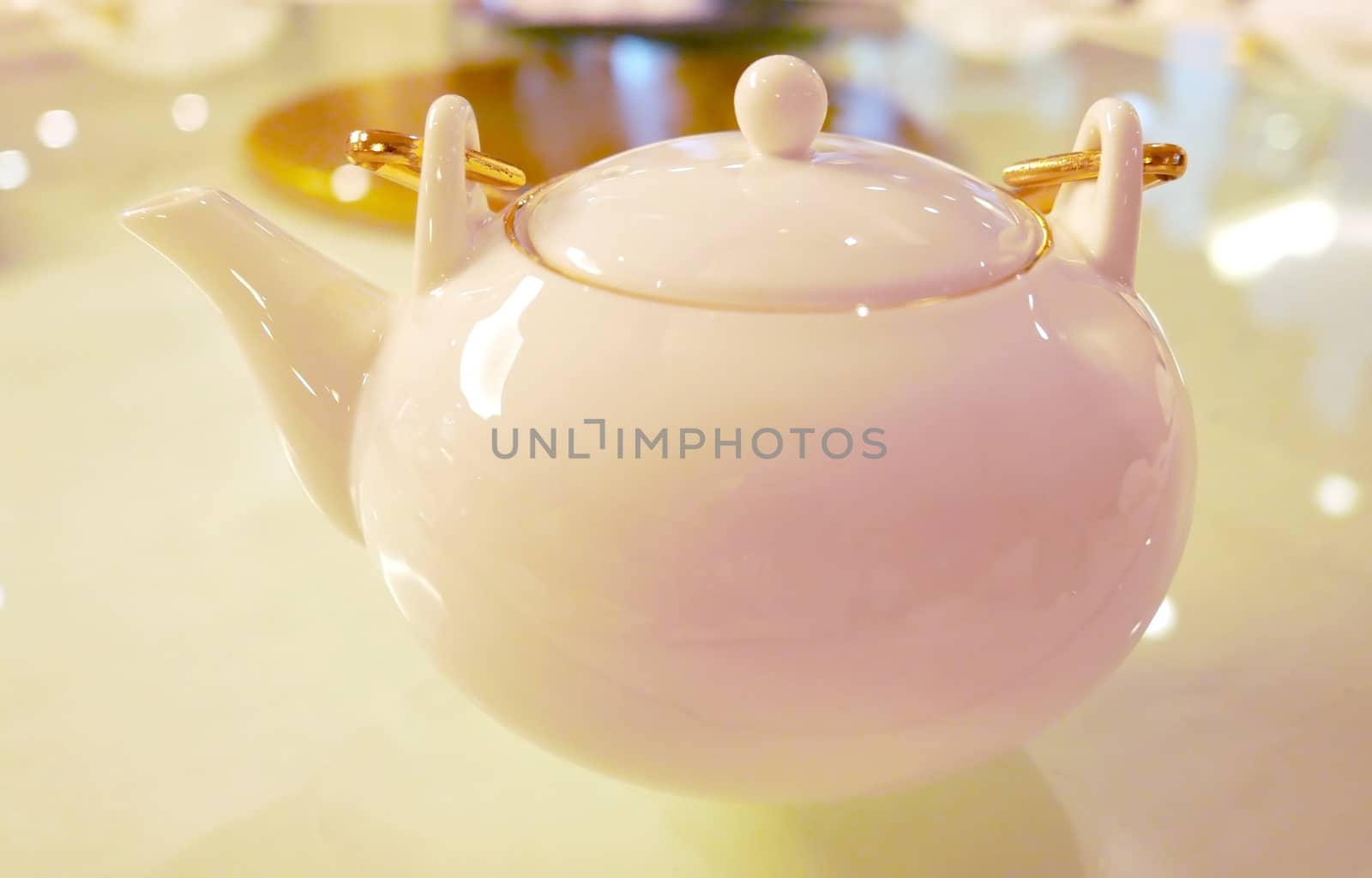 White teapot on table in Chinese restaurant by cougarsan