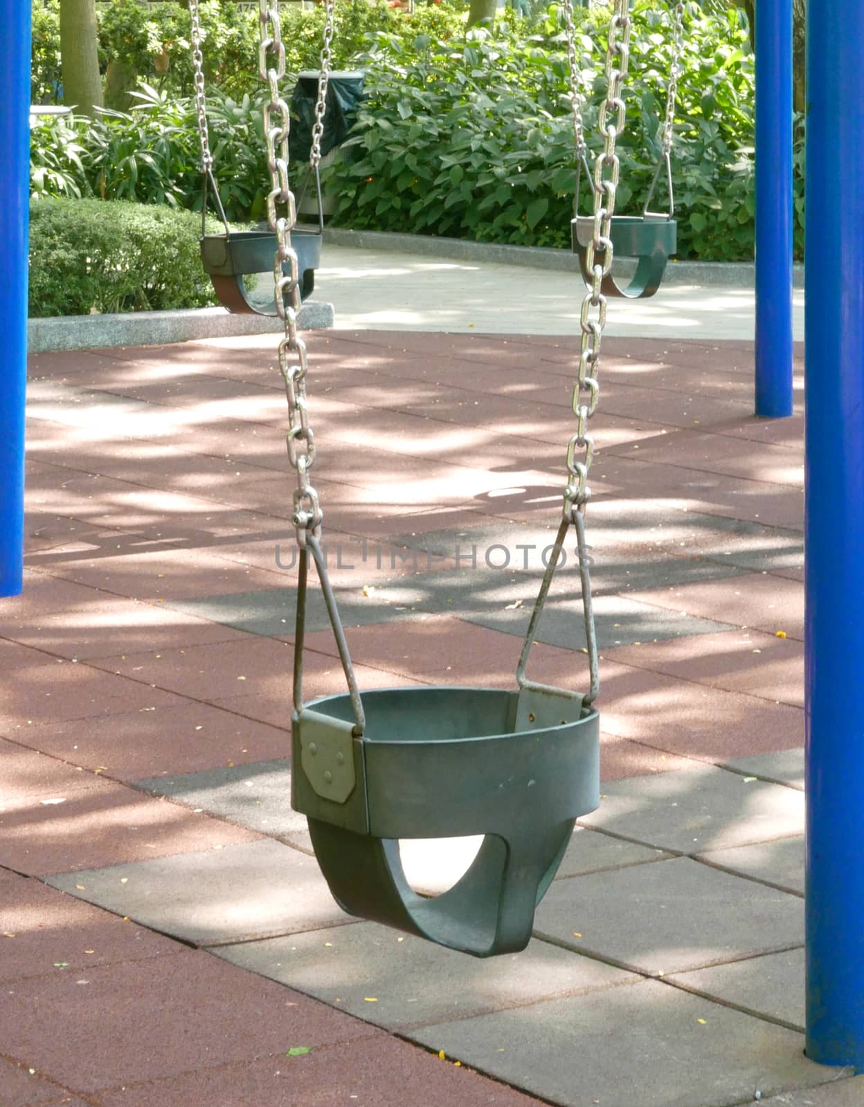 Children plastic swing in the park by cougarsan