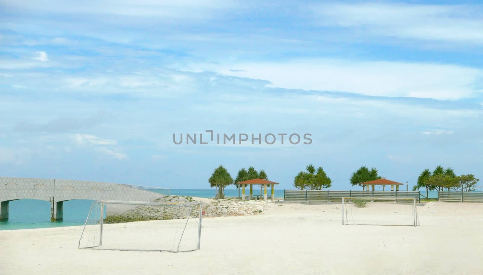 soccer goal net ,blue sky, tree and beach by cougarsan