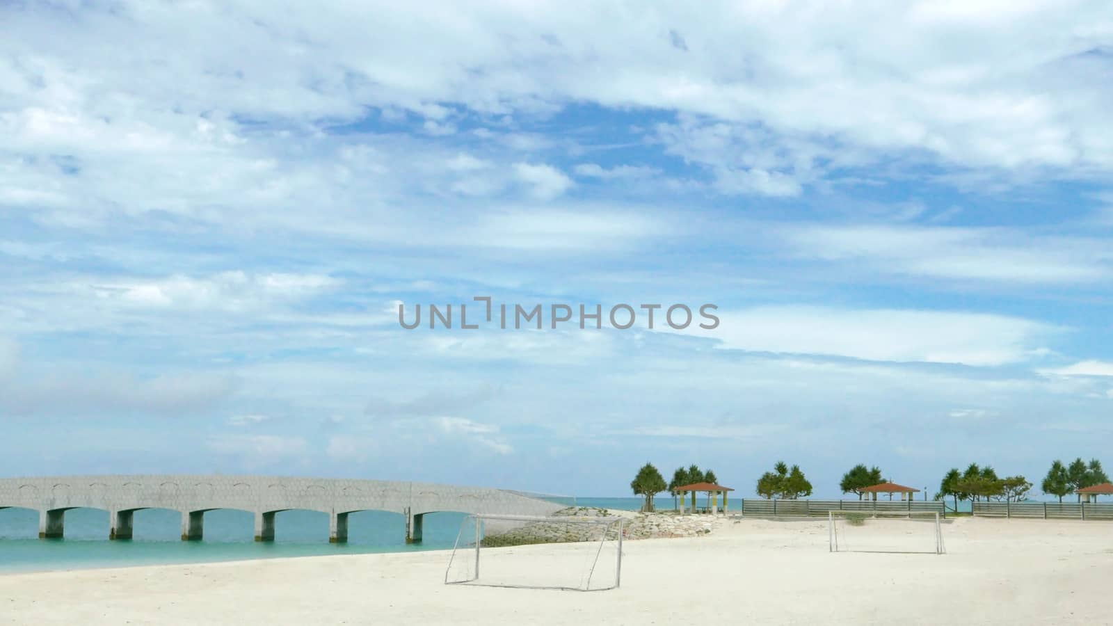 soccer goal net ,blue sky, tree and beach