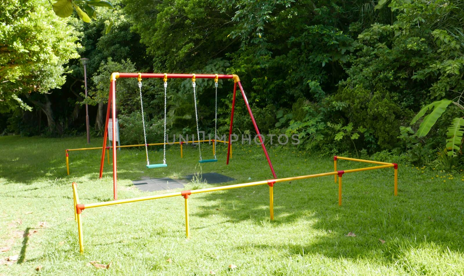 Colourful park swing on the grass