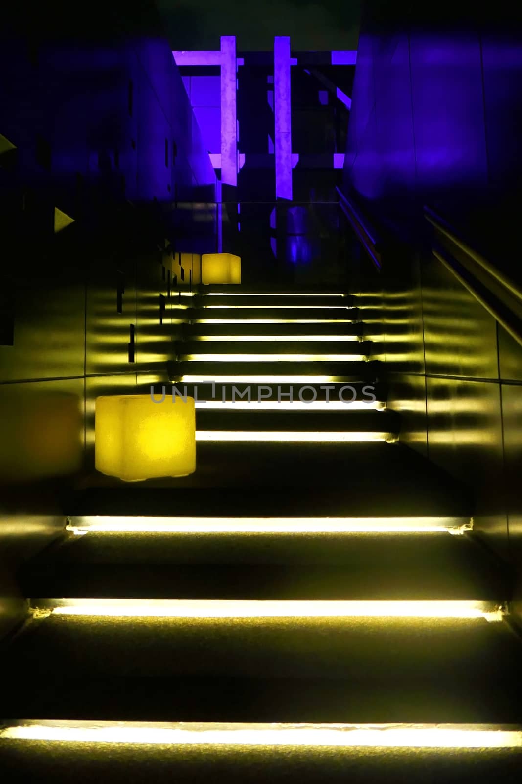 Yellow neon lit staircase inside the restaurant by cougarsan