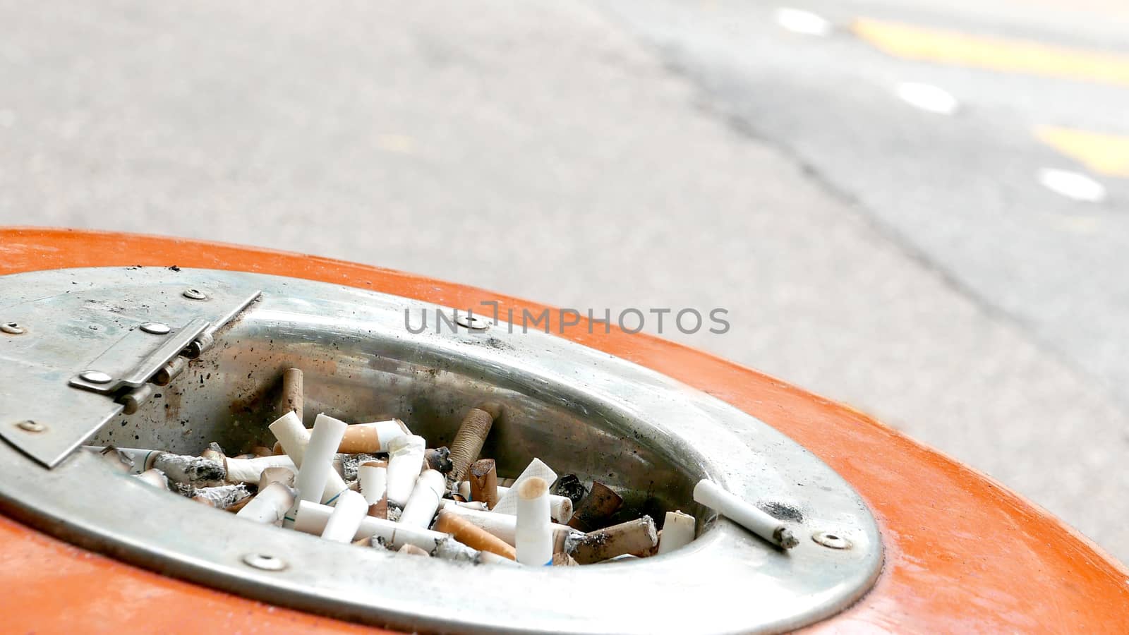 Cigarette butts on recycle bin by cougarsan