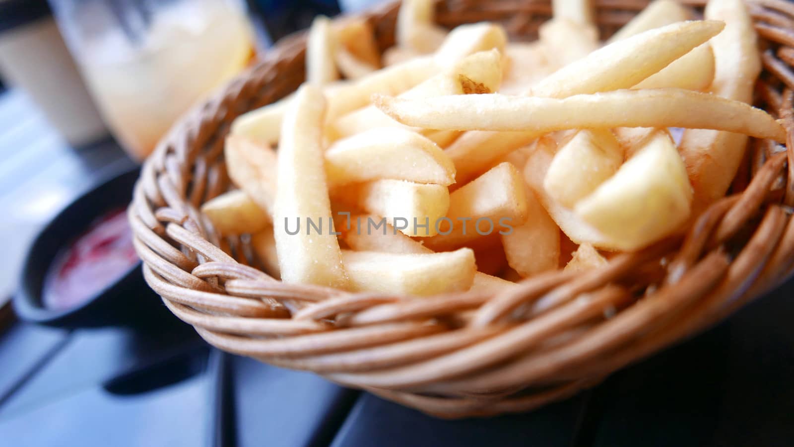 french fries in the brown basket and drink