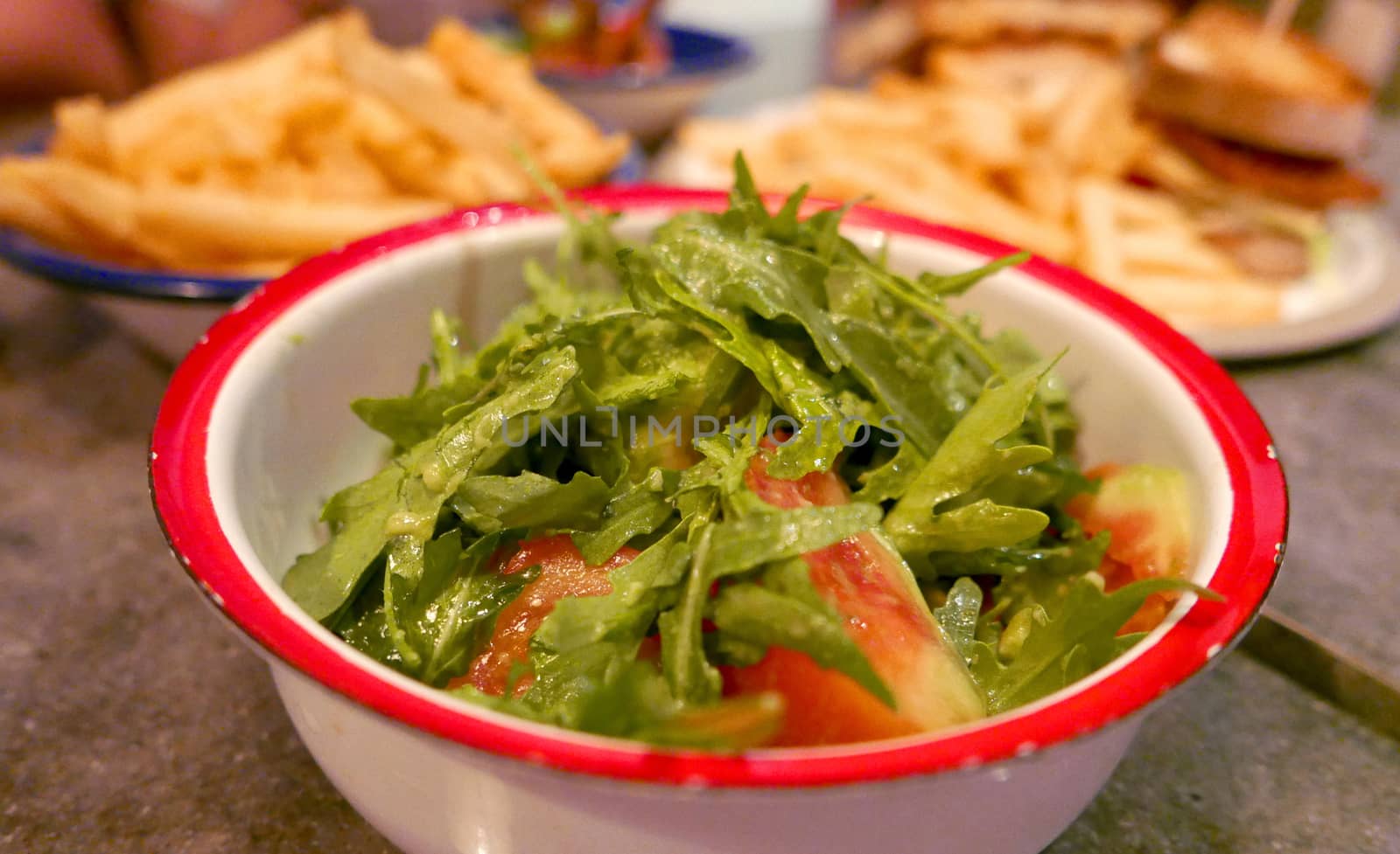 bowl of mizuna salad with some other dishes