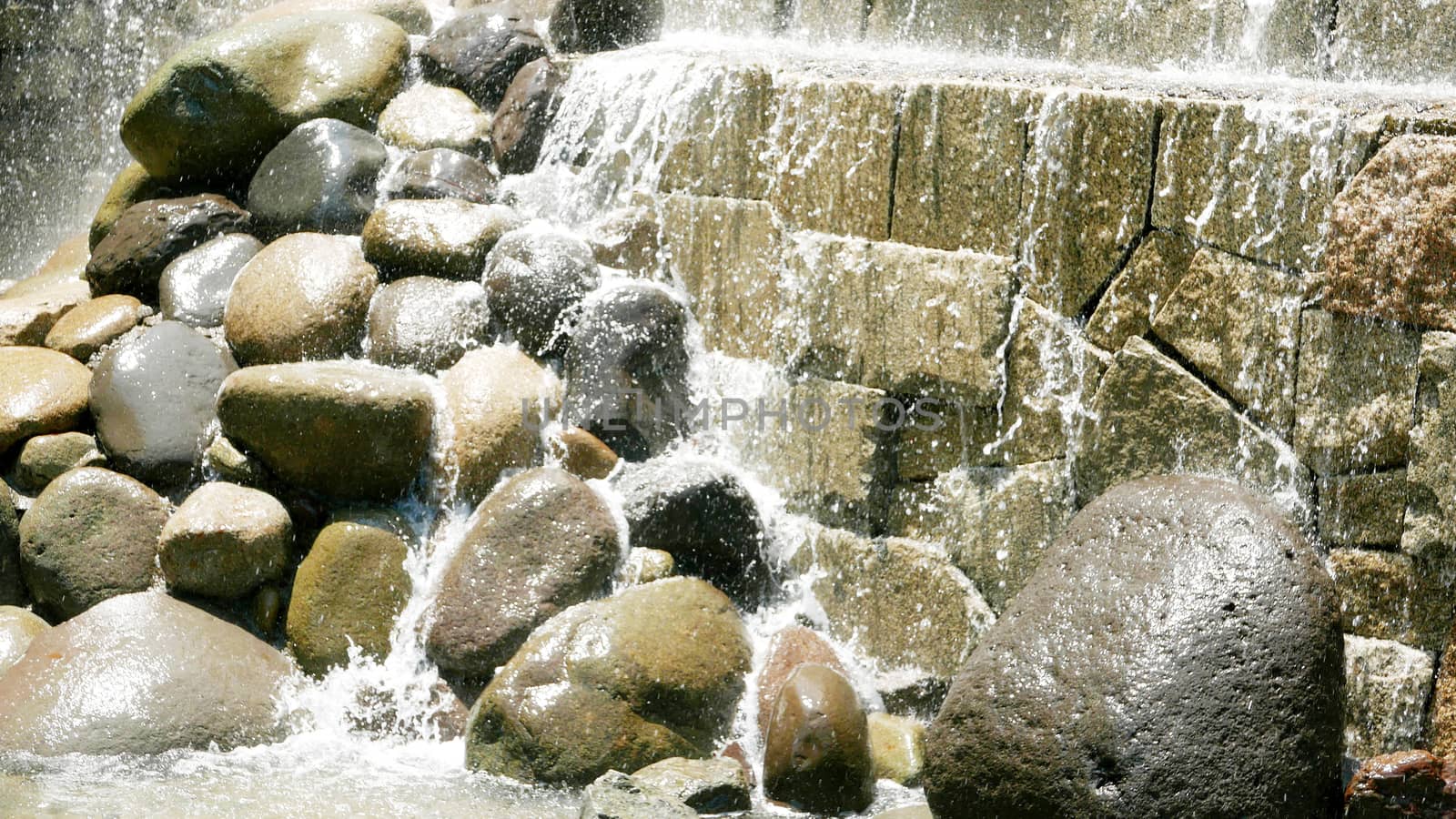 Abstract wet wall waterfall background in sunny day