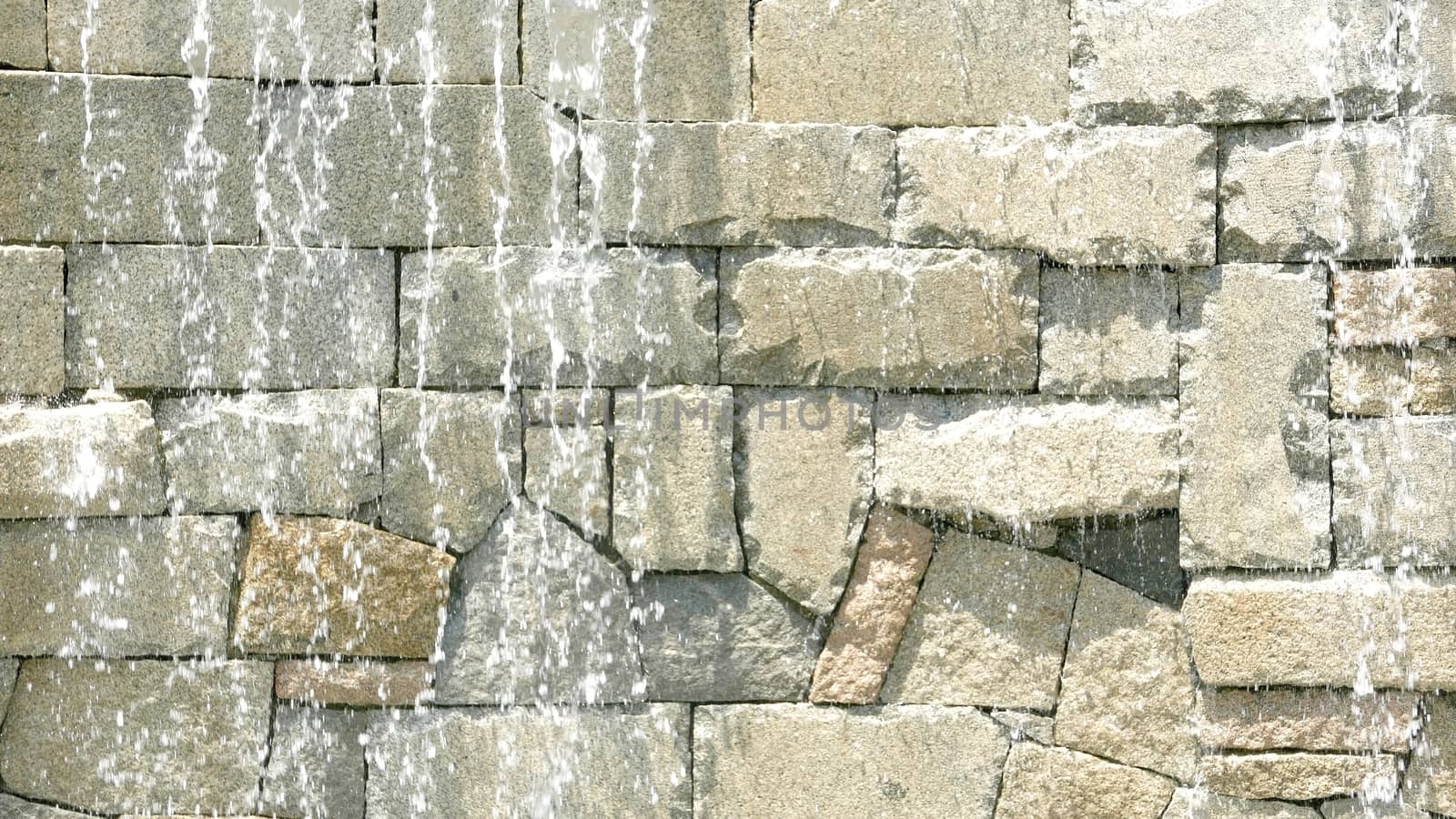 Abstract wet wall waterfall background in sunny day