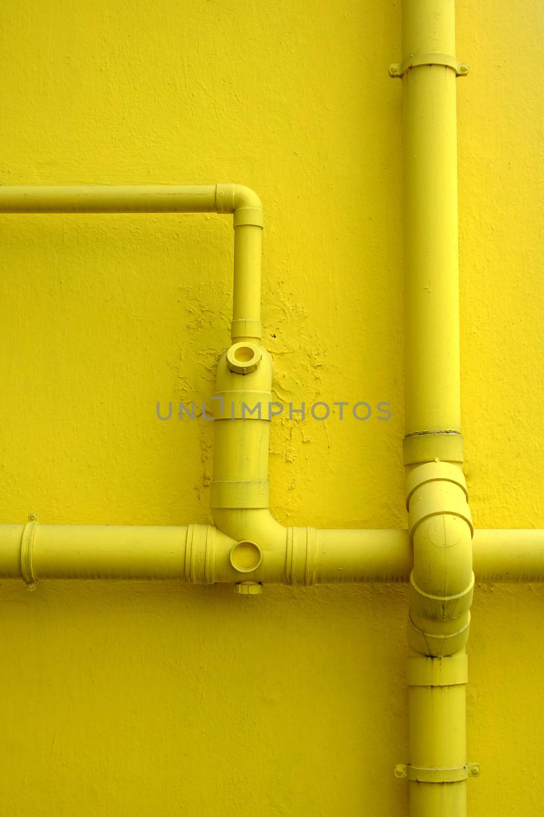 Yellow Building Wall and few Pipes