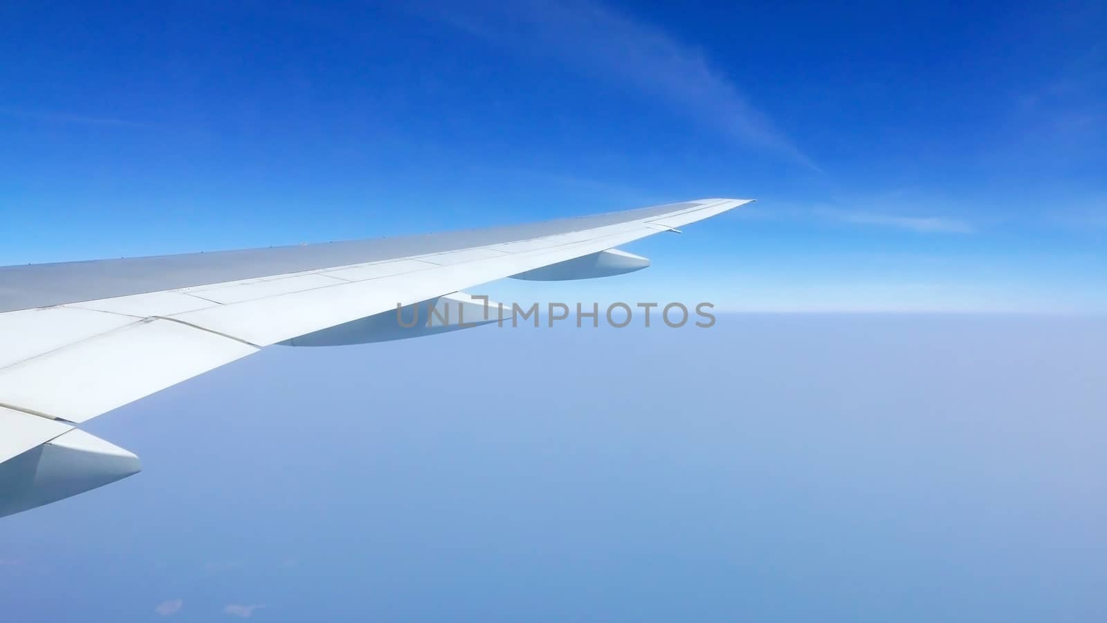 airplane wing and blue sky in the aerial view by cougarsan