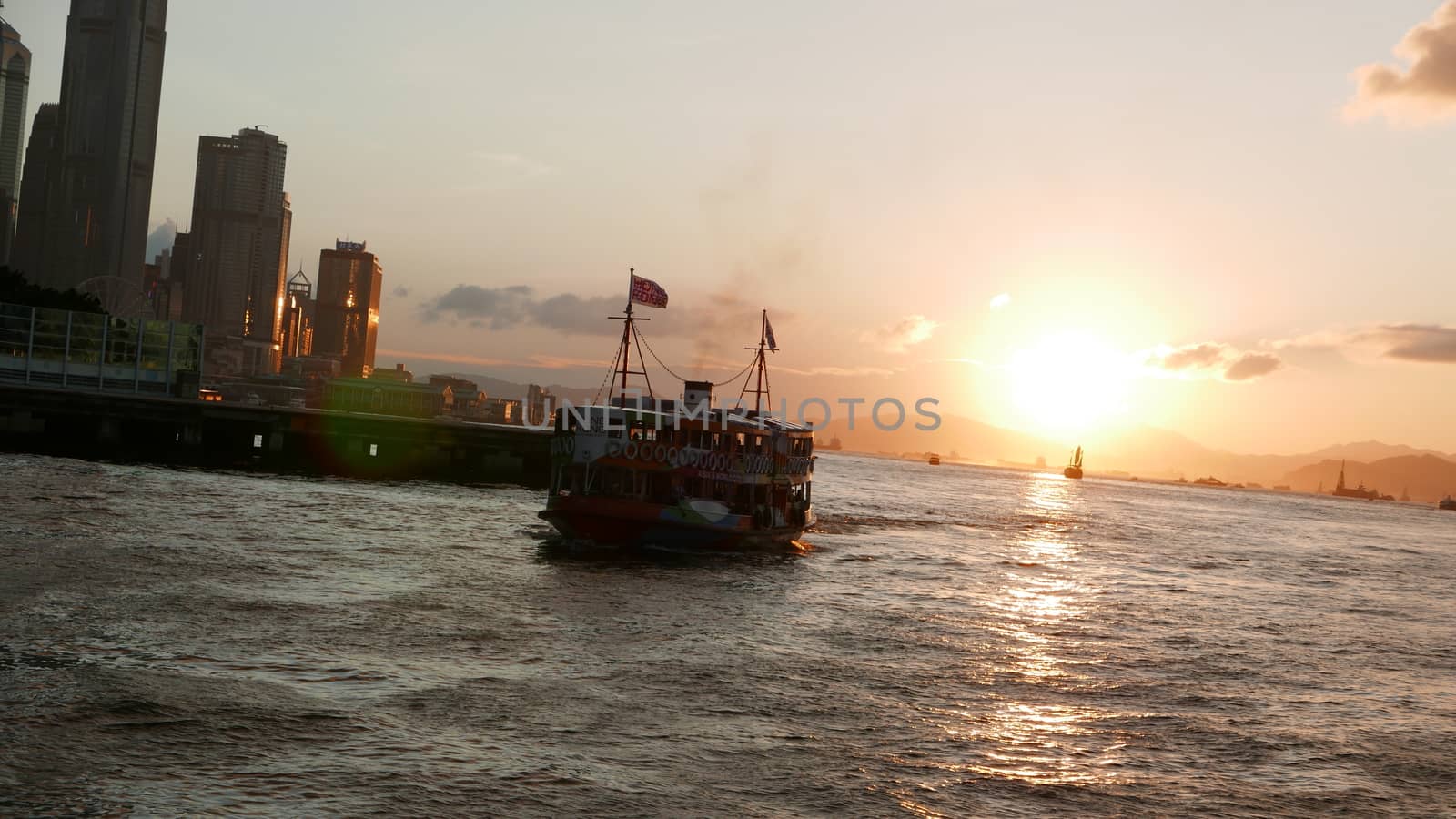 Hong Kong Victoria River, ferry and buildings at sunset