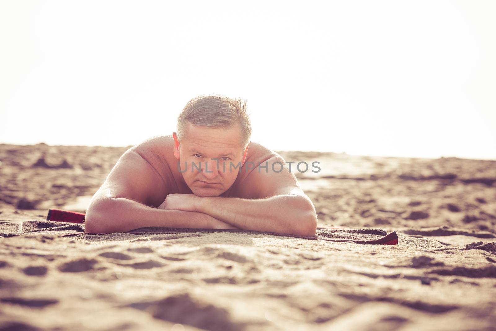 Man relaxing on sandy beach