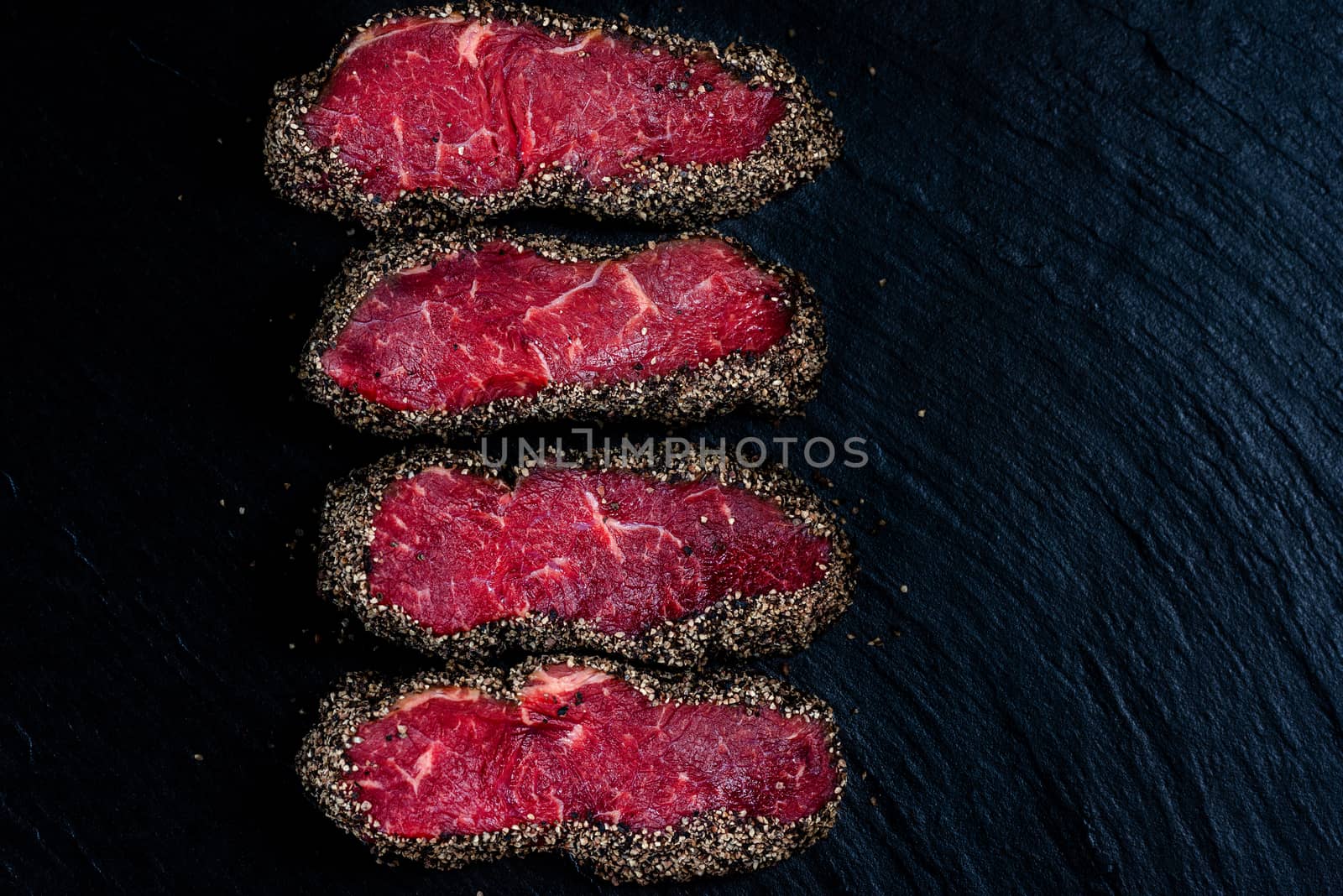 Pepper steaks on stone above view