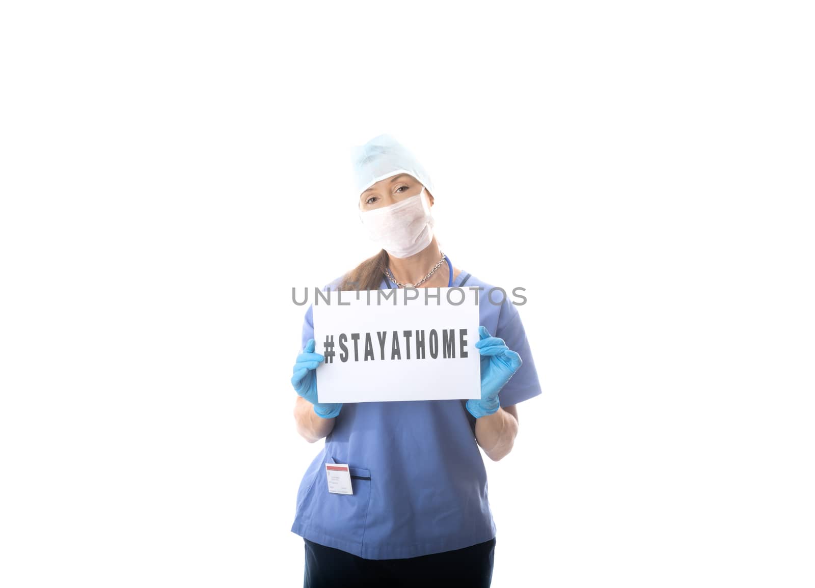 Nurse holding a sign to STAY AT HOME during virus COVID-19 pande by lovleah