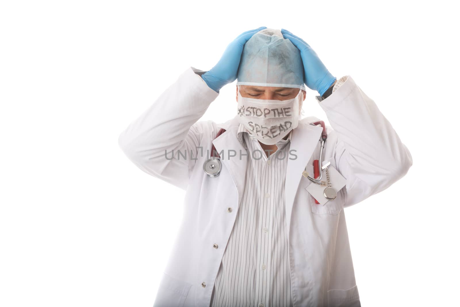 An anguished, overwhelmed or frustrated male doctor or surgeon in PPE with message to STOP THE SPREAD during virus pandemic SARS,COVID-19 coronavirus or otherinfectious outbreak