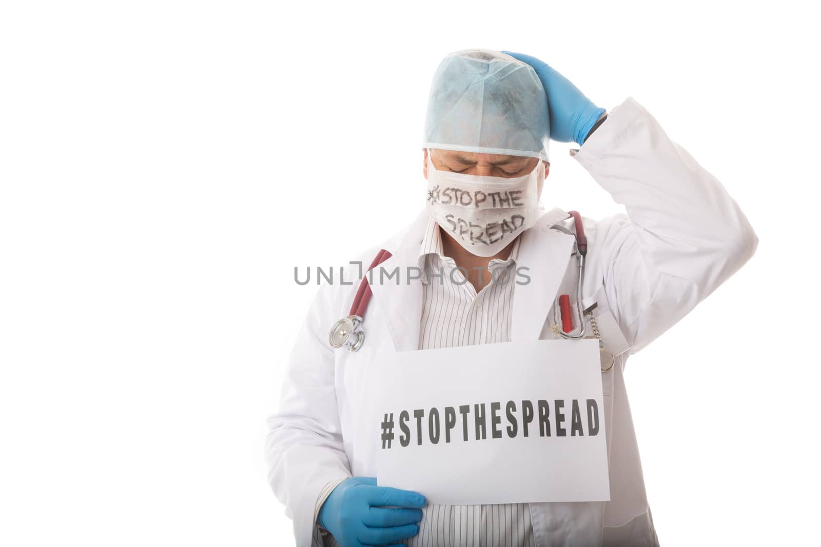 Overwhelmed doctor holding side with hashtag advising to STOP THE SPREAD of infectious virus pandemic such as SARS, COVID-19, H1N1 or other infectious virus or influenza