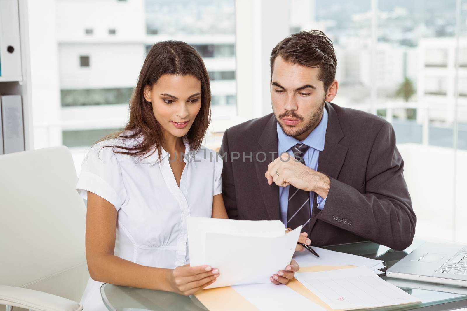 Two young business people in meeting at office