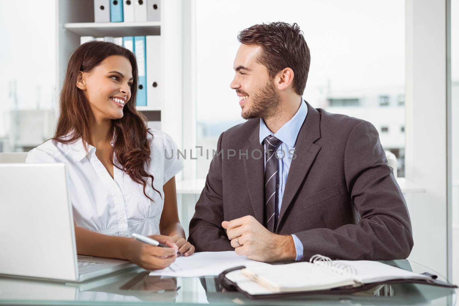 Two young business people in meeting at office
