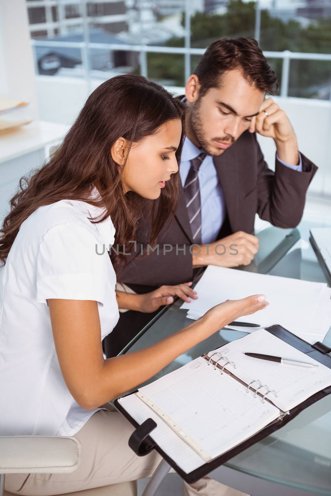 Two young business people in meeting at office