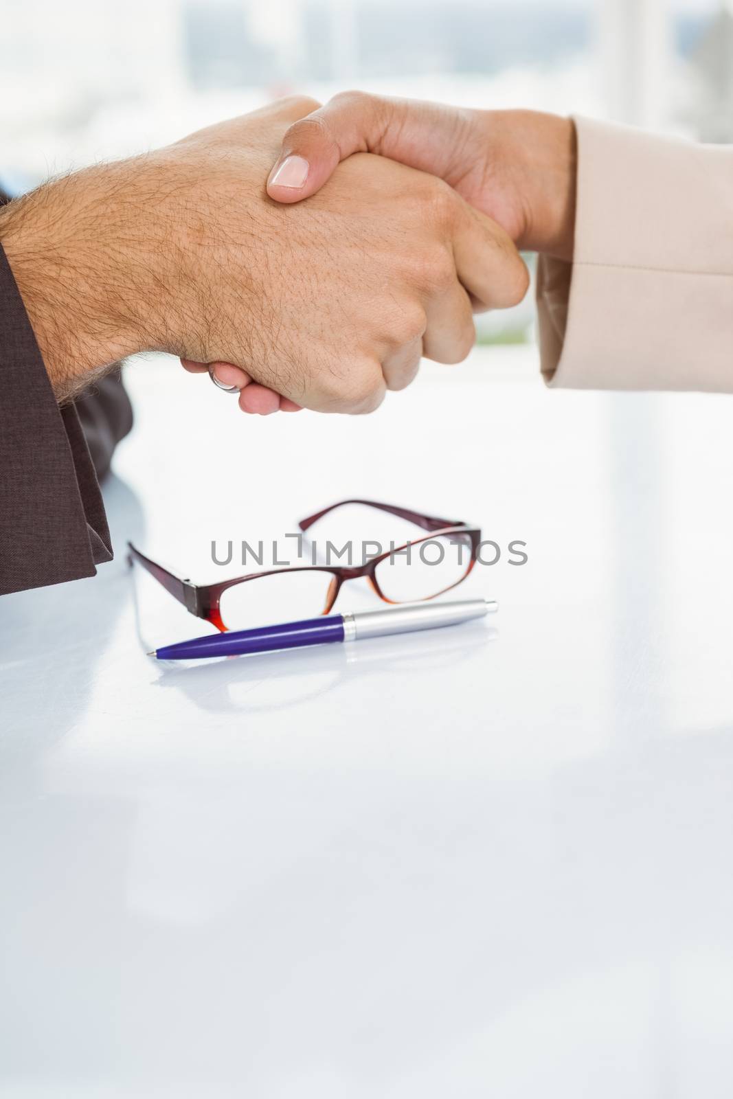 Close-up of business people shaking hands by Wavebreakmedia