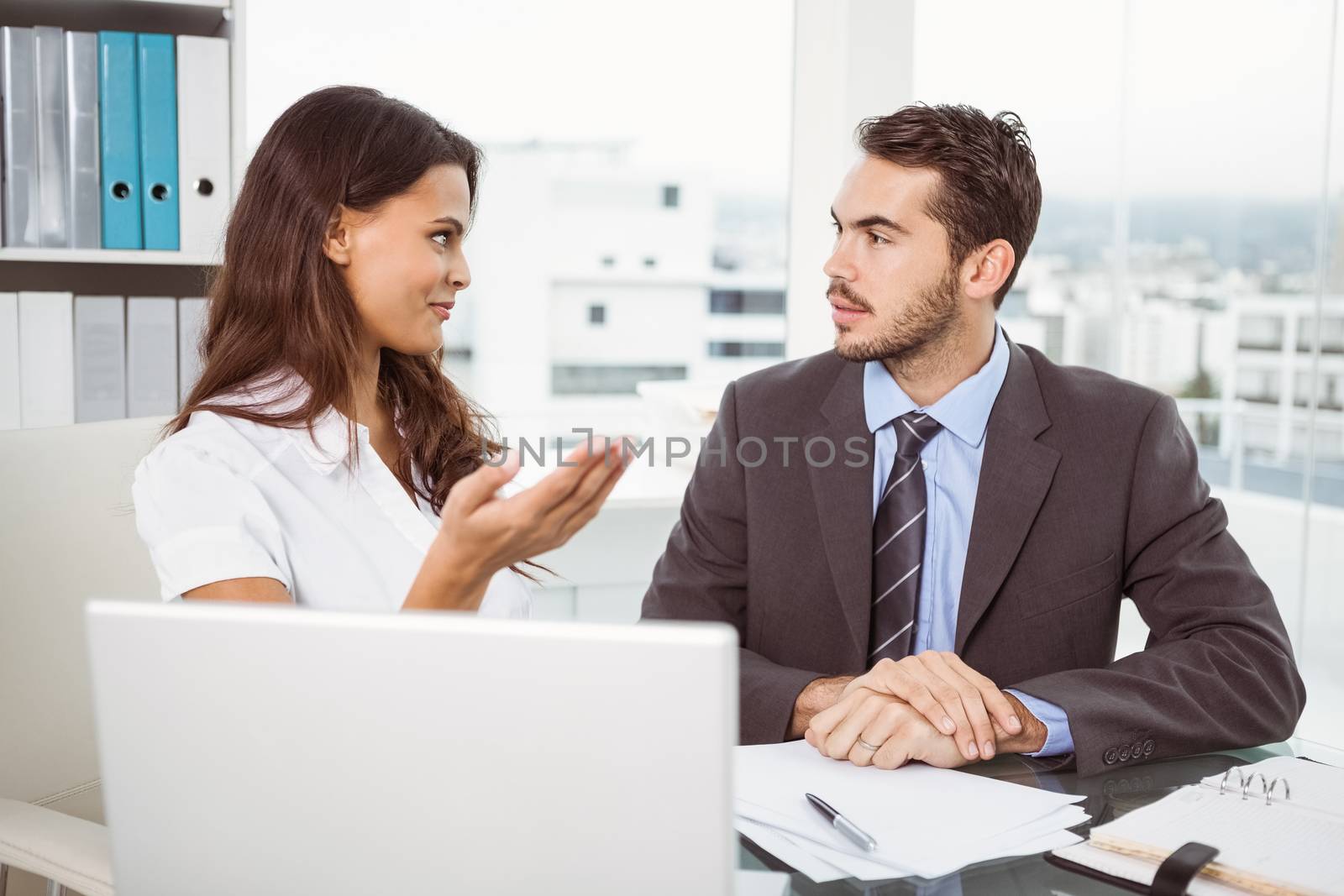 Two young business people in meeting at office