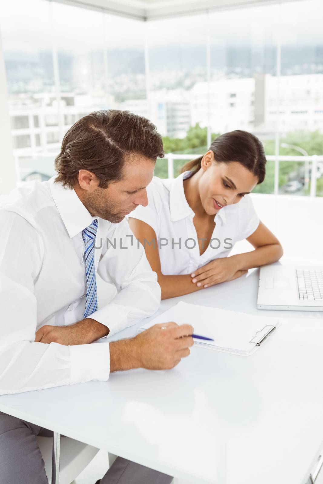 Two young business people in meeting at office