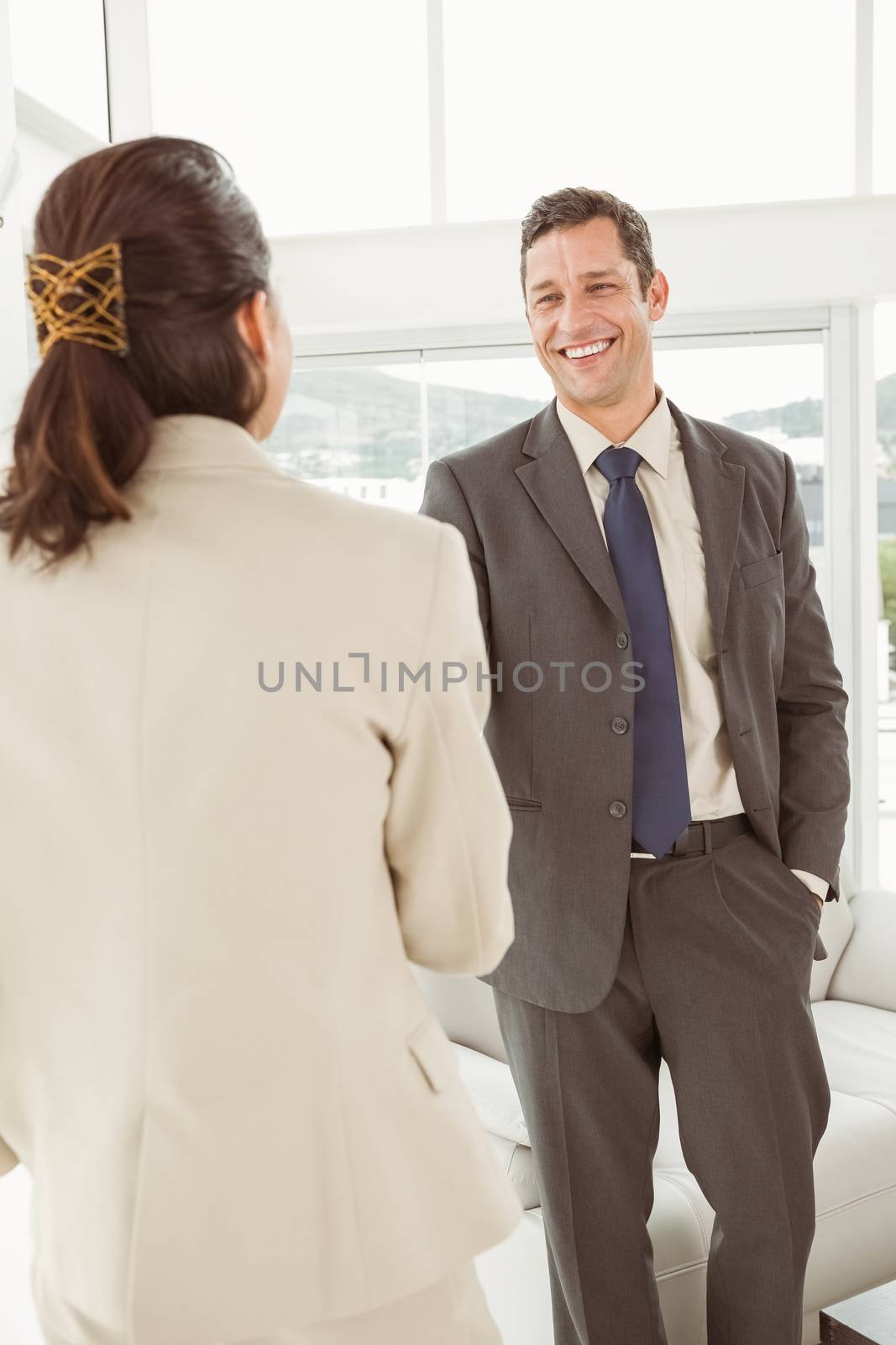 Two happy young business people in the office