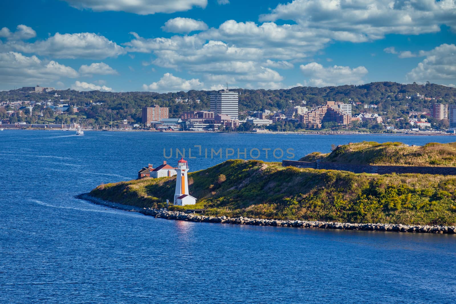 Orange and White Lighthouse at Entrance to Harbor by dbvirago