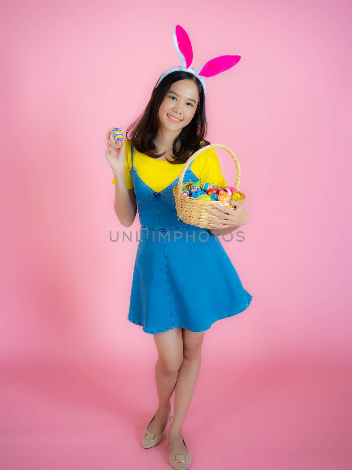 A happy young woman prepares to celebrate Easter by panyajampatong