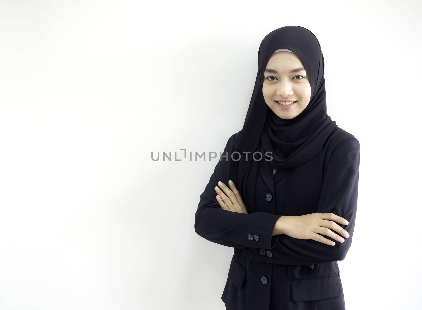 Smart beautiful Asian Muslim woman in modern kurung and hijab. by panyajampatong