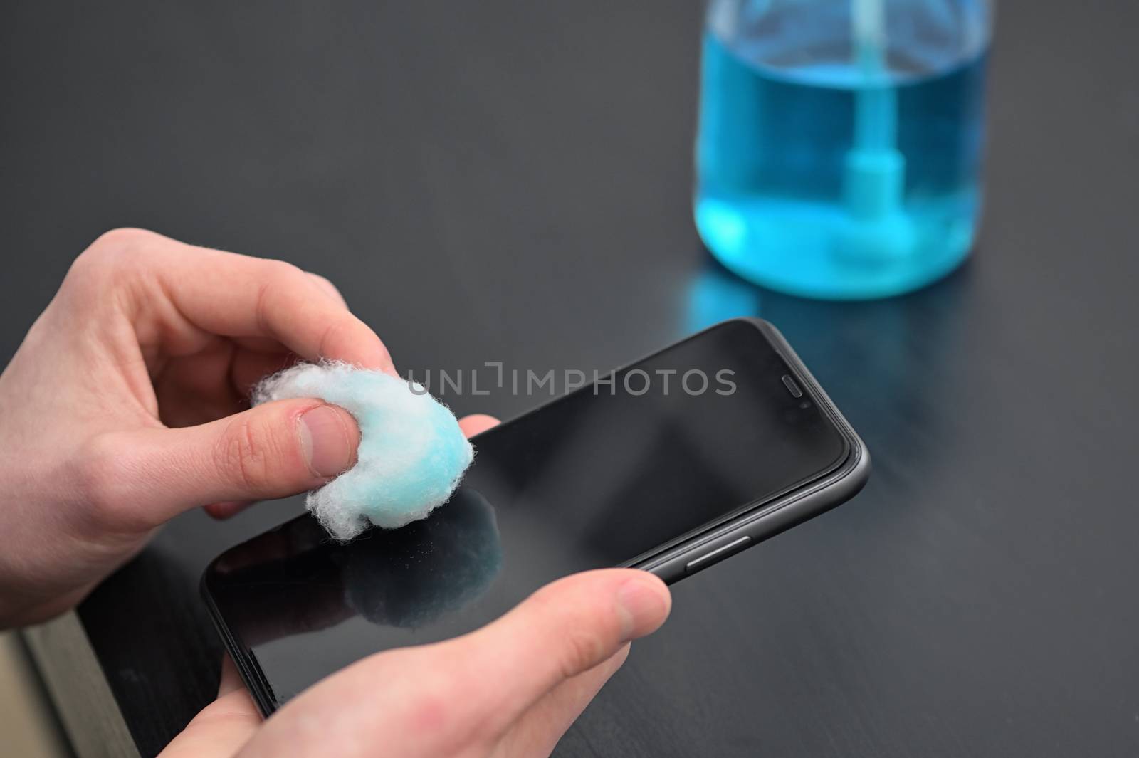 Man Cleaning Smartphone Screen With Alcohol  by mady70