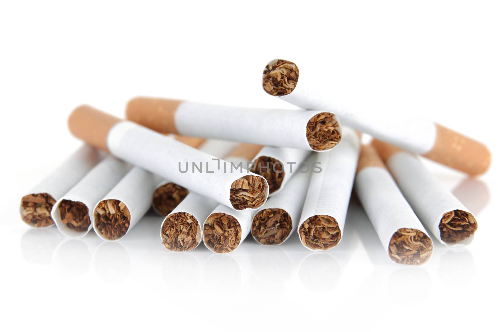 A pile of cigarettes on white background with selective focus