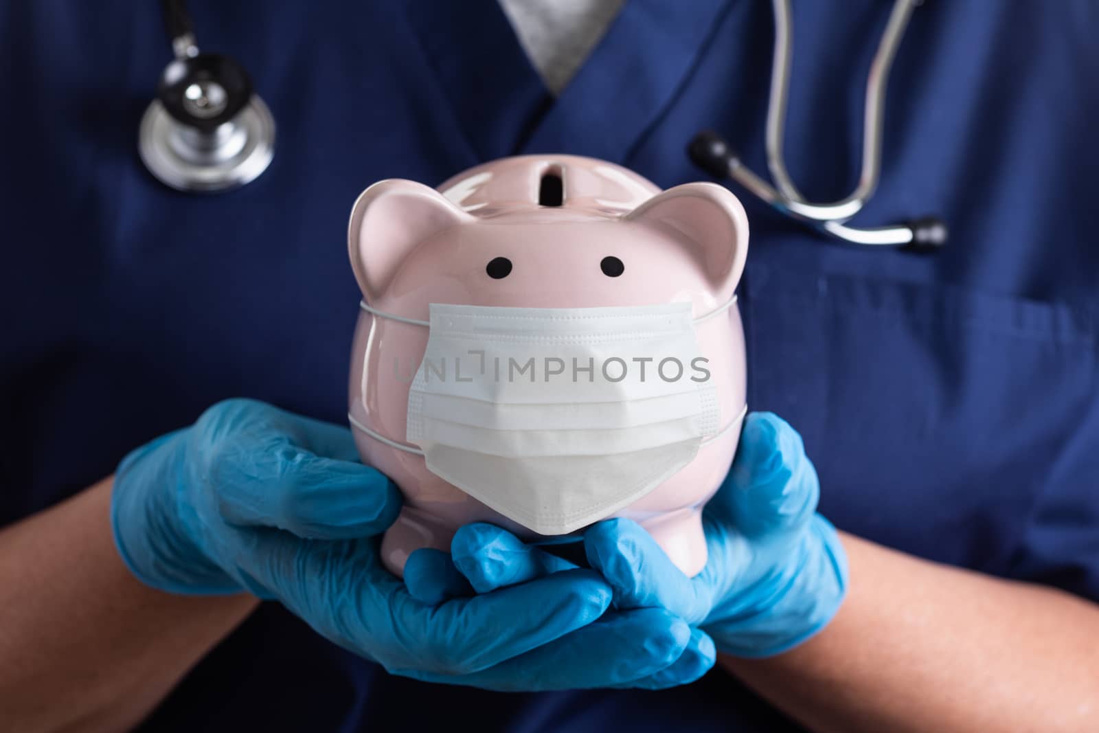 Doctor or Nurse Wearing Surgical Gloves Holding Piggy Bank Wearing Medical Face Mask. by Feverpitched