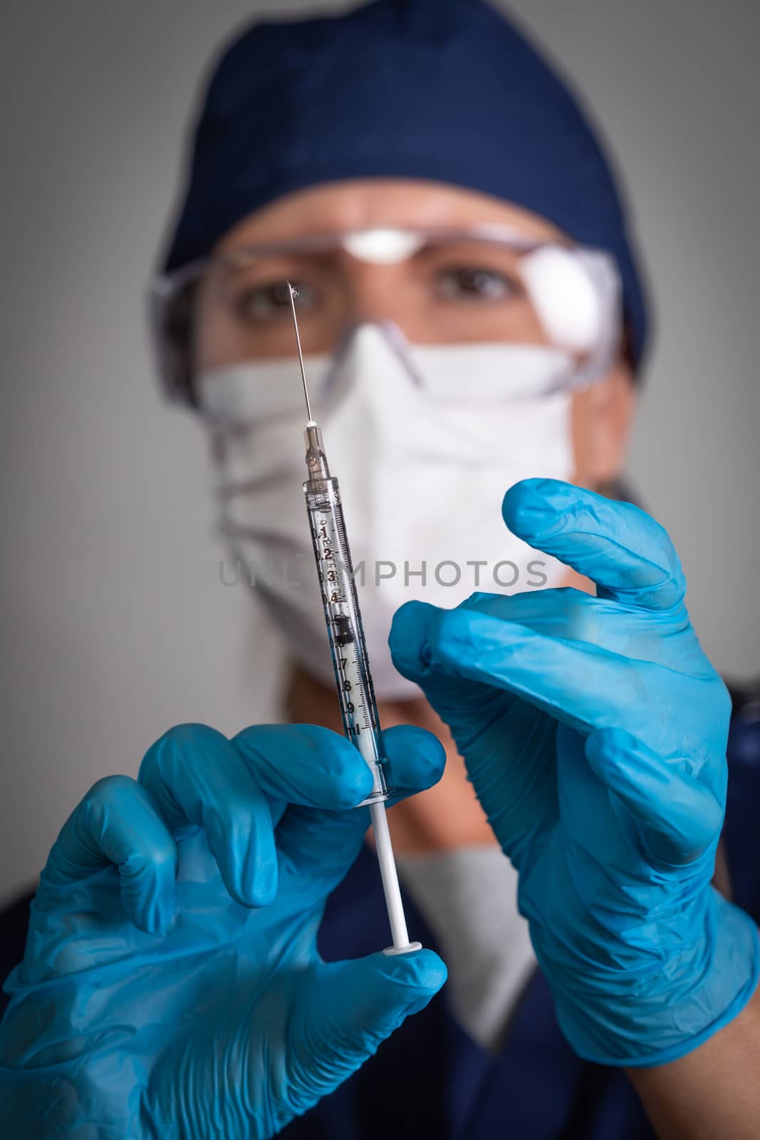 Doctor or Nurse Holding Medical Syringe with Needle by Feverpitched