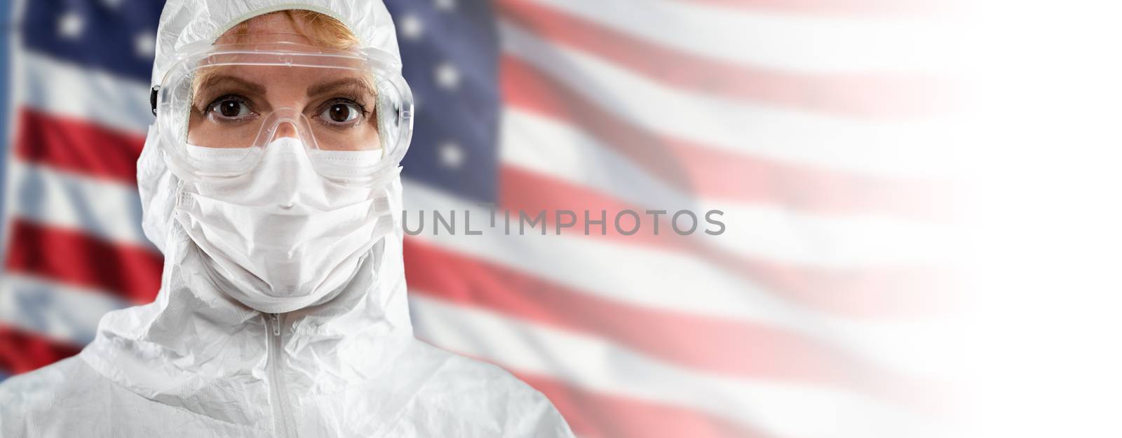 Doctor or Nurse Wearing Medical Personal Protective Equipment (PPE) Against The American Flag Banner. by Feverpitched