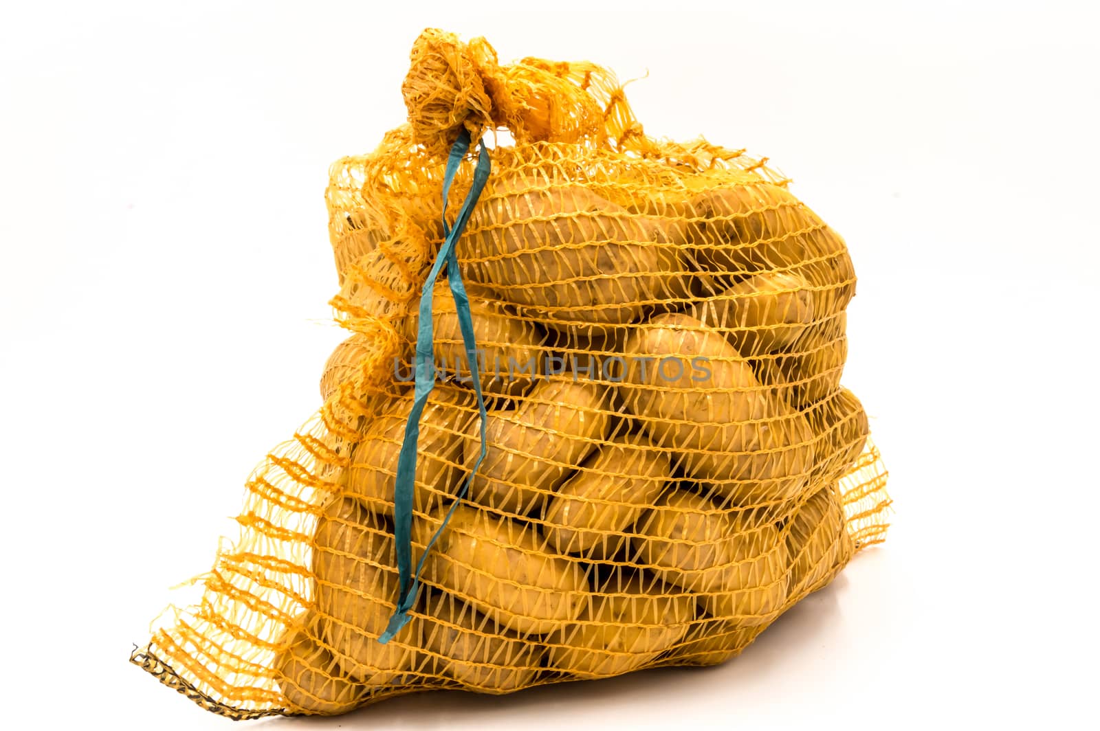 Ripe potatoes in burlap sack isolated on white background