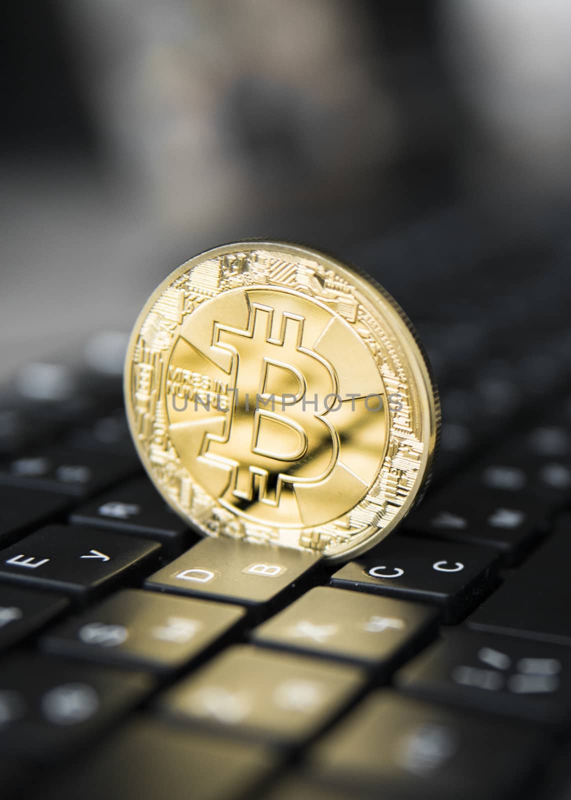Golden bitcoin on a keyboard. Bitcoin crypto currency on a computer black keyboard. Digital currency. Virtual money. Metal coins of bitcoin. Bussiness, commercial, Exchange
