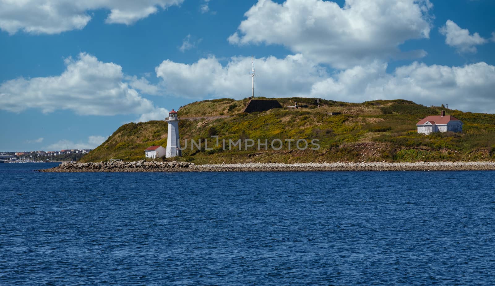 White Lighthouse on shore of green island near Halifax, Nova Scotia