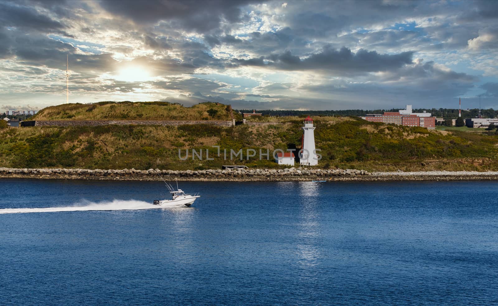 White Motorboat Approaching White Lighthouse in Halifax by dbvirago