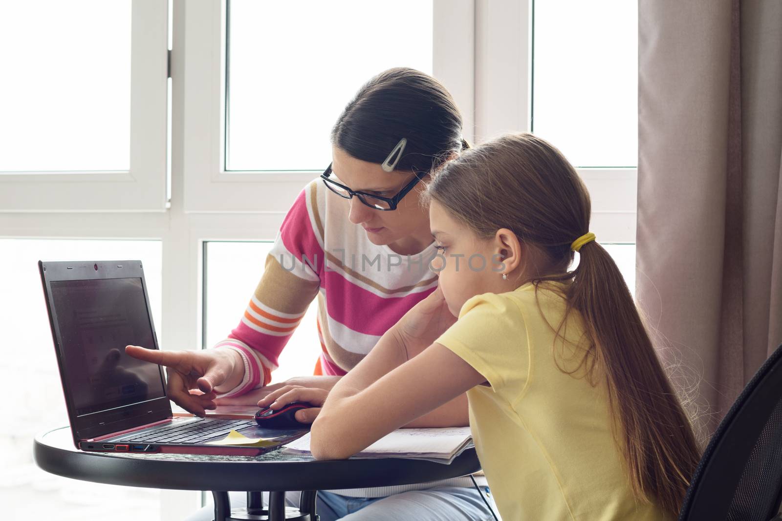 Girl helps girl figure out how to use the Internet