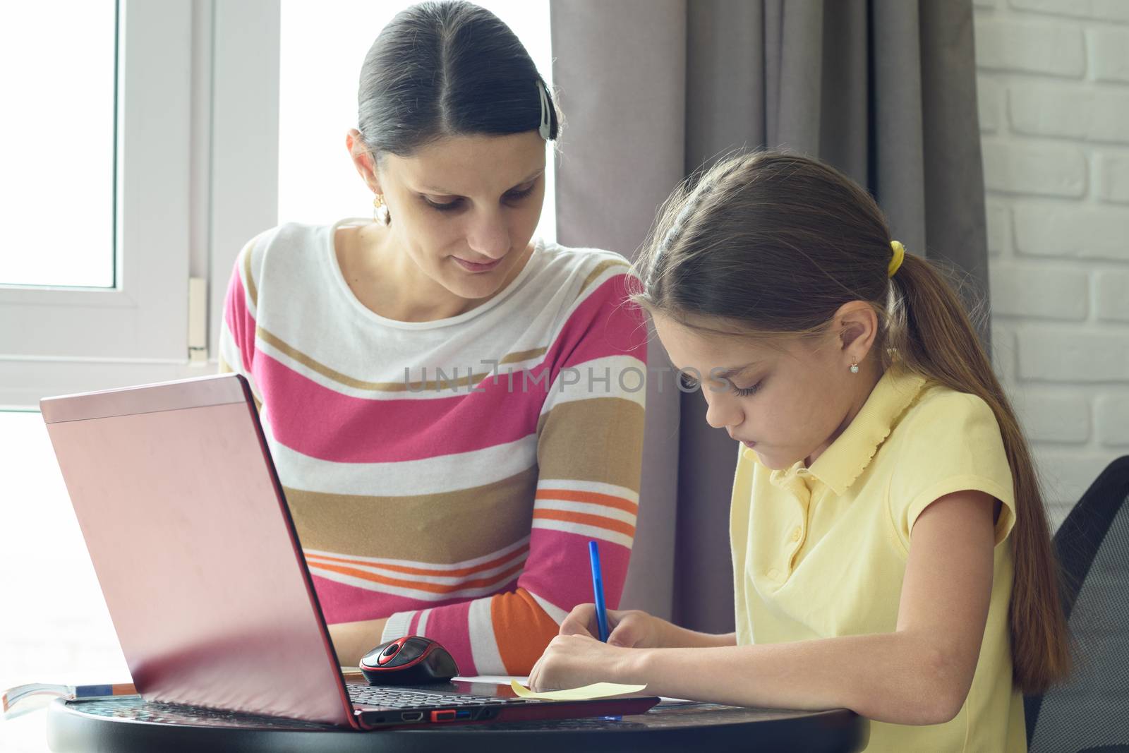 Tutor and teaching do homework by the window in the room